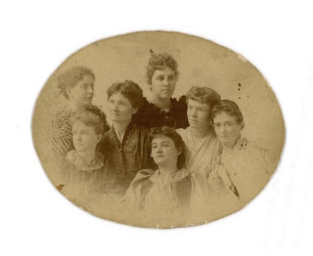 An oval portrait of Gwyneth King Roe with Emilie Neidlinger, Emily Bishop-Netha, Dorothy Bishop, Adalaide (Adelaide) Jones, Gertrude Bishop, and Lucia Benedict. "Calling ourselves The Muses."